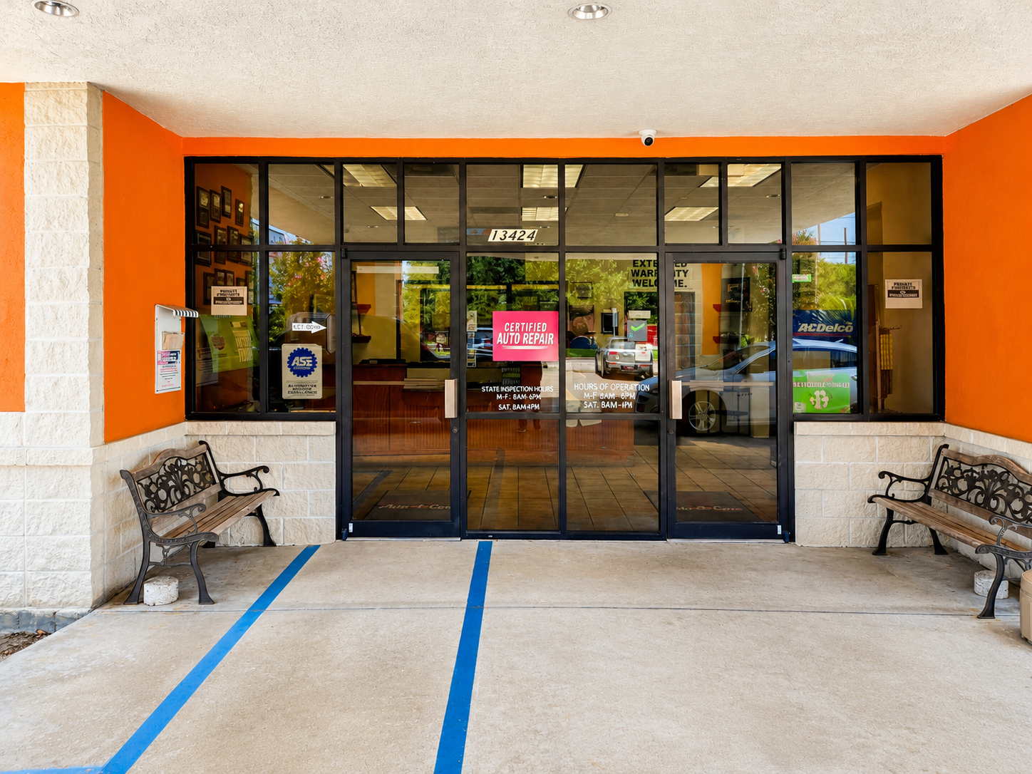 Certified auto repair doorway with ASE and AAA decals at Auto Care USA Briar Forest