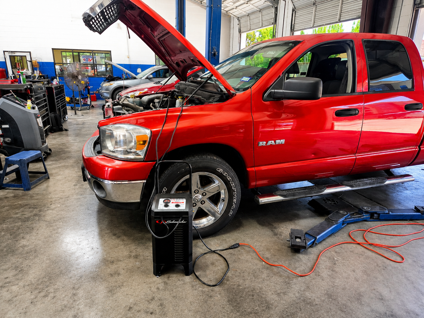 Dodge Ram truck being serviced in a bay at Auto Care USA Briar Forest