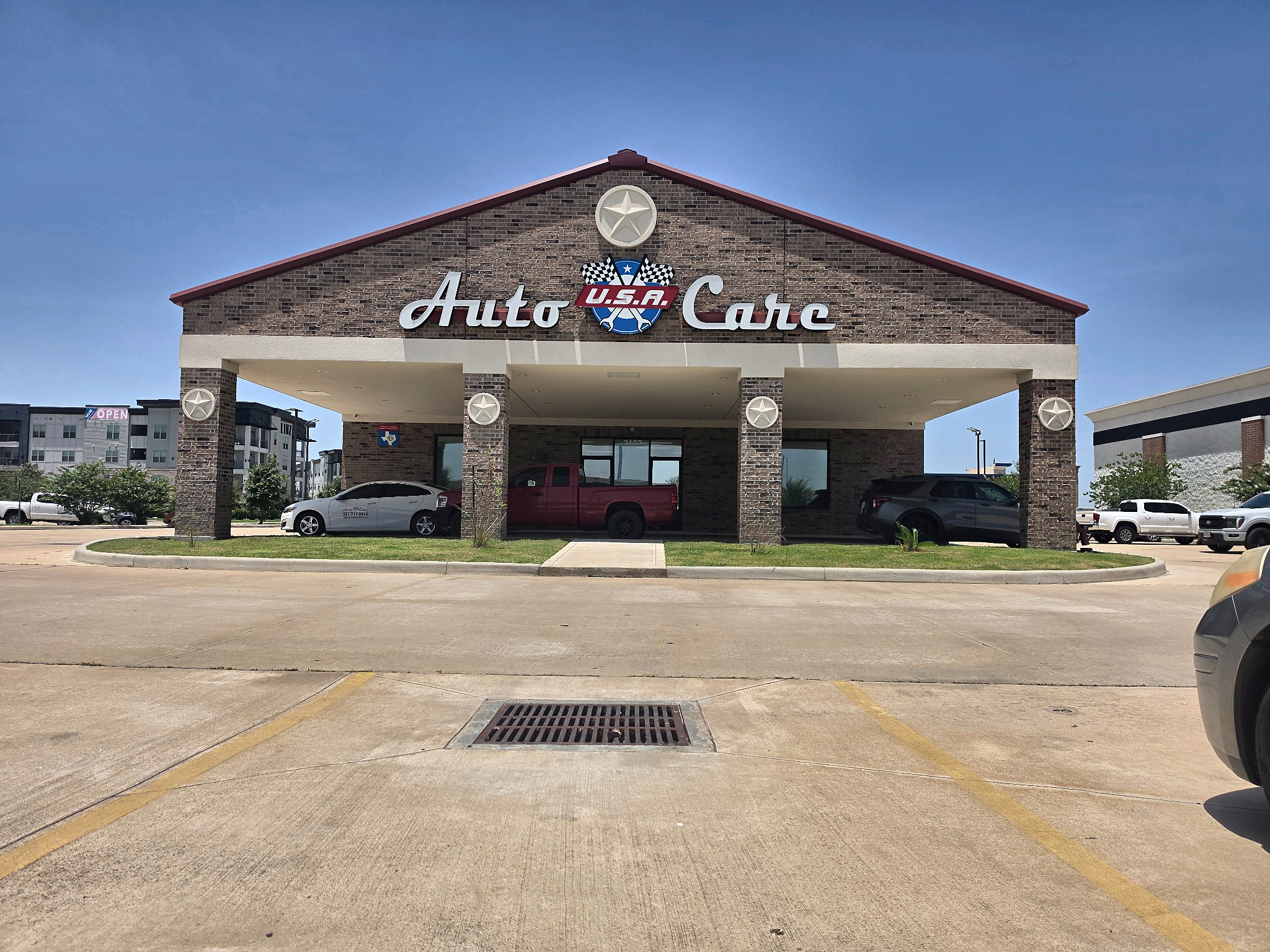 Trusted mechanic shop storefront and covered drive-up at Auto Care USA in Katy, TX
