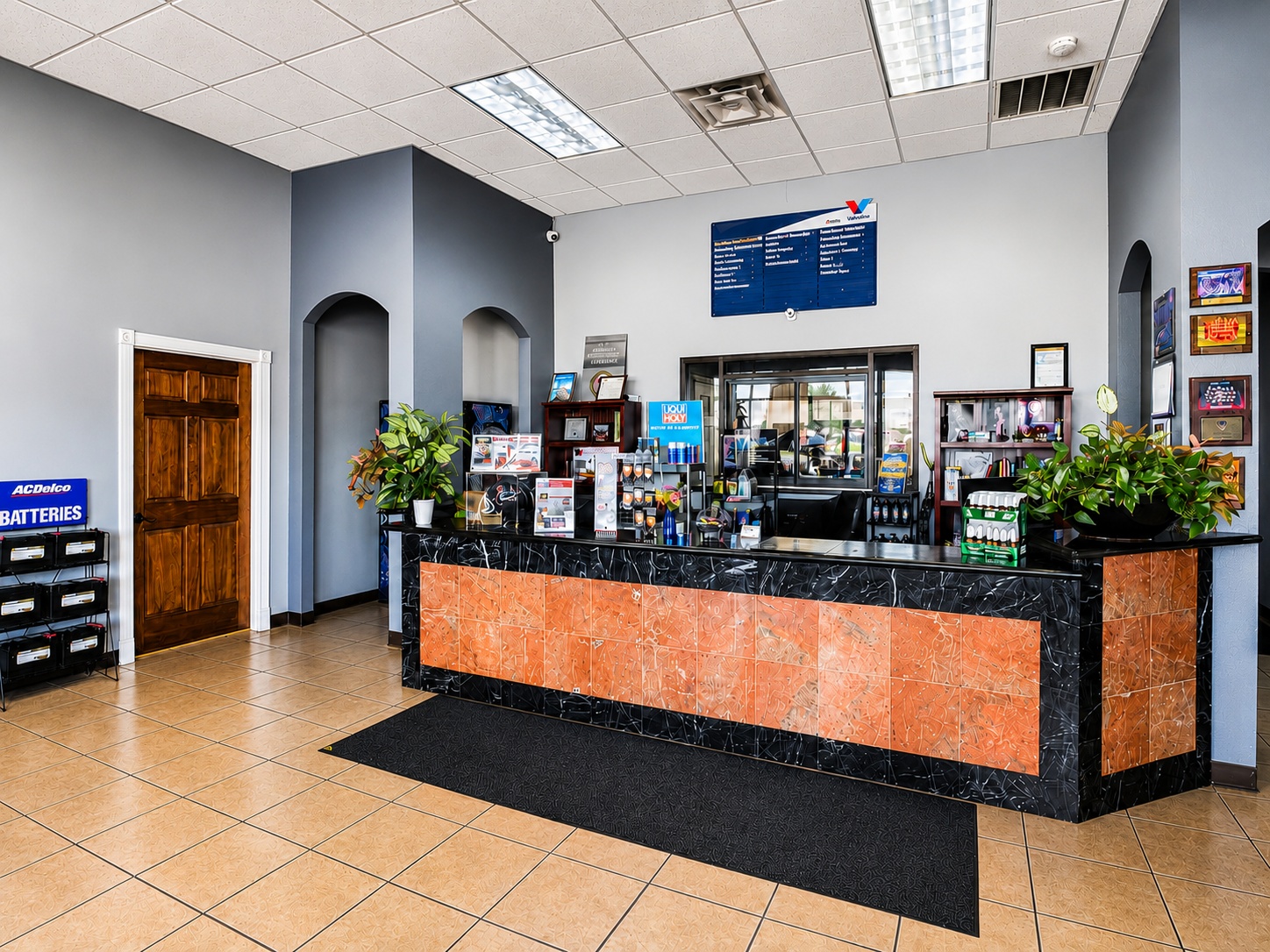 Front desk and lobby with product displays at Auto Care USA in Spring, TX